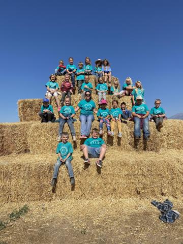 Students sitting on hay
