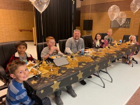 Students having lunch with Mr. Murray