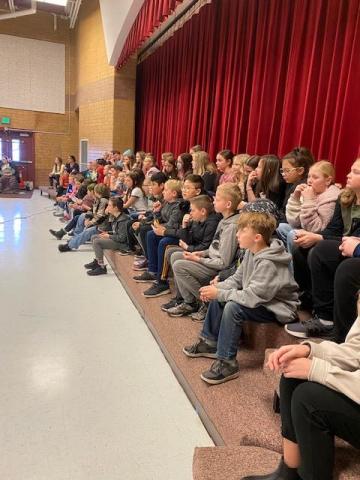 fifth graders watching performance