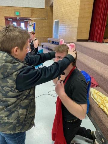 students helping to dress the characters