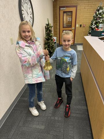 two kids holding bell