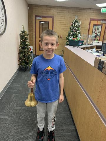 boy holding bell