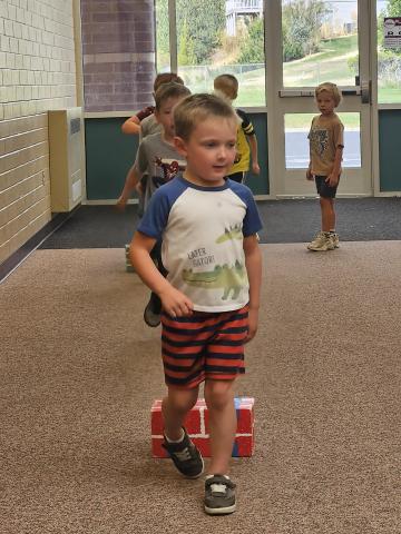 kids jumping over block