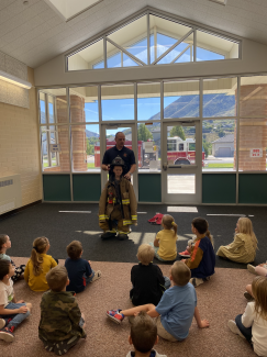 Mr Taylor teaching the kinds about firefighters