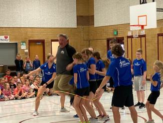 Mr. Murray jumping with 6 kids